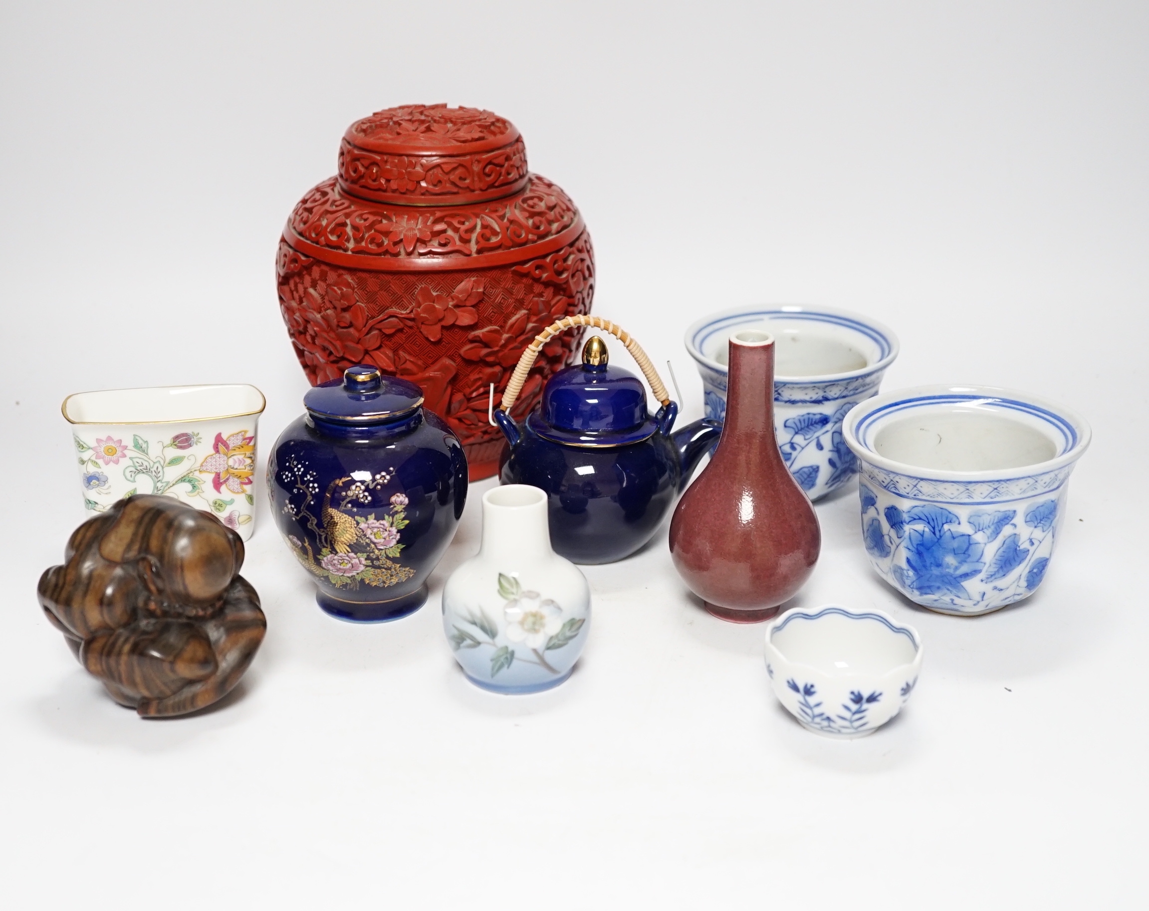 A Chinese cinnabar lacquer jar and cover, a Chinese copper red bottle vase, a carved wood figure, a Meissen miniature bowl and other ceramics, jar 15cm